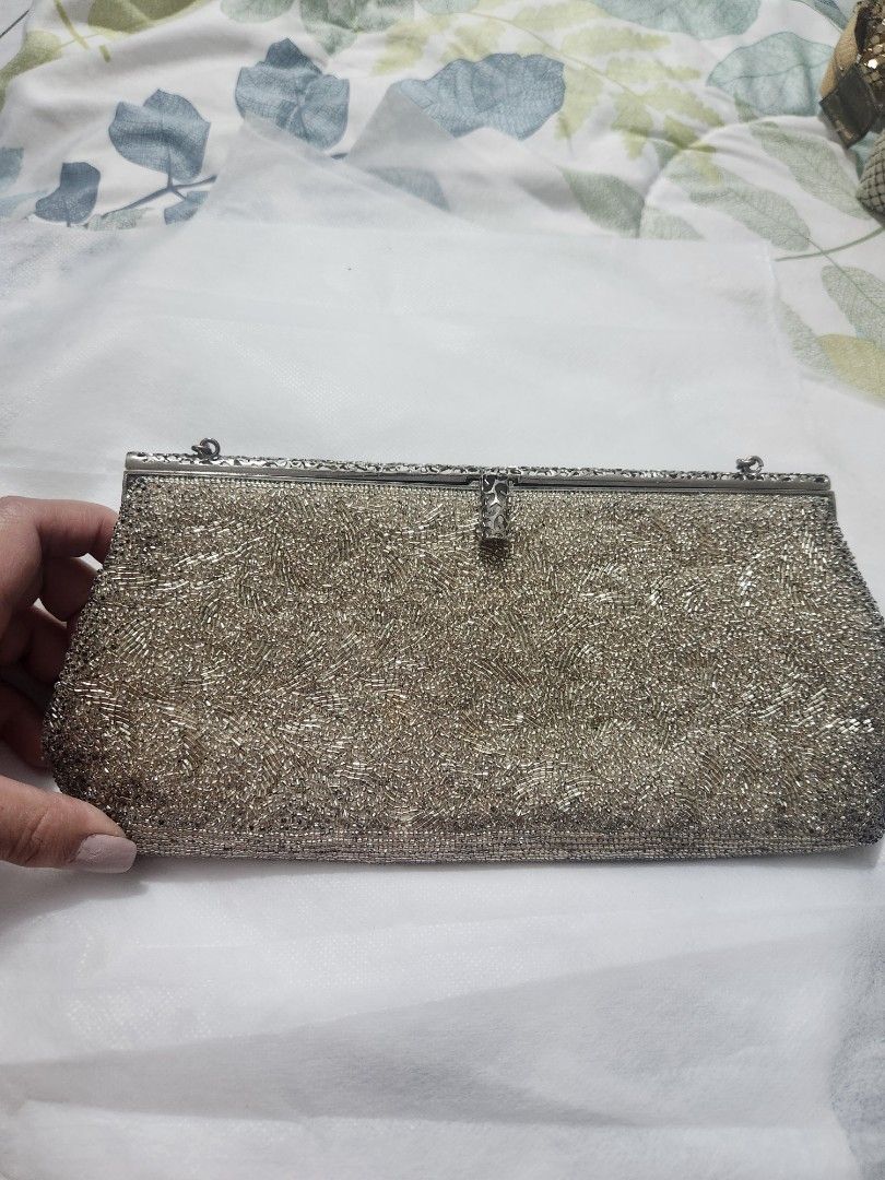 Silver beaded evening clutch bag with top handle (Category: Clutches) located in Quezon City. Submitted by mmstorres042181 (Listing ID 1465672735, Image 2). Description: - Sparkly silver beaded evening bag - Secure metal frame and clasp closure - Single matching beaded handle - Clean interior lining - Fits phone, cards, and lipstick - Perfect for weddings, dinners, and parties.