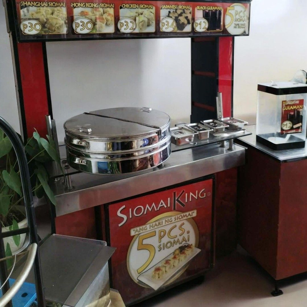 Siomai King Food Cart Stall - Complete Setup (Category: Industrial Equipment) located in Antipolo. Submitted by goodsinger (Listing ID 1458353962, Image 2). Description: - Siomai King food cart stall for sale - Includes main counter, signage, and menu display - Menu items: Shanghai Siomai (P28), Hong Kong Siomai (P28), Chicken Siomai (P30), Japanese Siomai (P33), Black Gulaman (P10) - Features 'Ang Hari ng Siomai' branding - Ready for business.