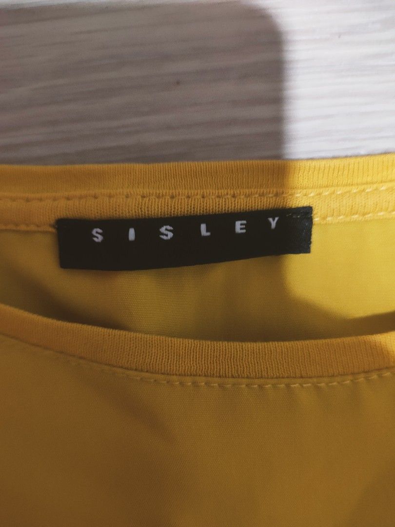 Sisley Yellow Long Sleeve Blouse Size S (Category: Blouses) located in Manila. Submitted by afforlux (Listing ID 1465668718, Image 3). Description: - Brand: Sisley - Size: S (Brand new with tags attached) - Color: Bright yellow - Fit: Relaxed fit with dropped shoulders - Hem: Curved high-low hem - Material: Lightweight, beautifully draping fabric - Perfect for: Daytime outfits or layering.