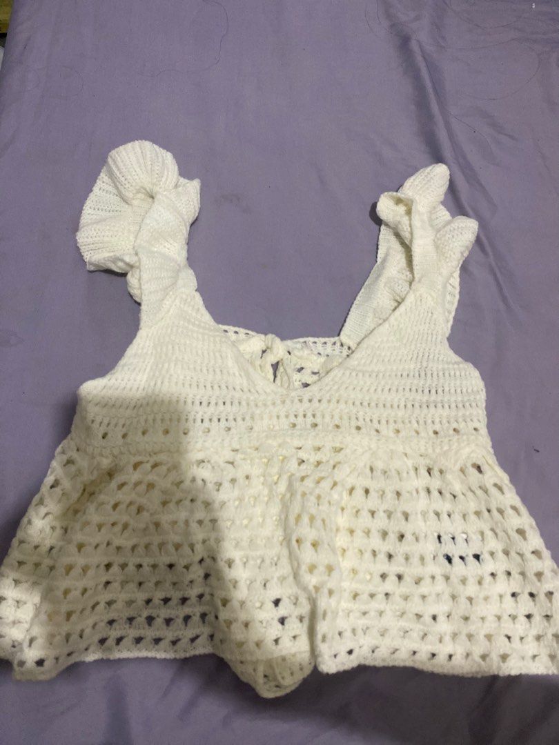 Soleia Women Solid Color Crochet Top With Back Bow (Category: Sleeveless) located in Quezon City. Submitted by dyuulii (Listing ID 1465673088, Image 1). Description: - Brand: Soleia - Style: Sleeveless crochet crop top - Details: Sweetheart neckline, ruffle straps, open back with self-tie bow, and flowy peplum hem with knitted openwork pattern - Fabric: Lightweight and breathable - Perfect for: Summer beach trips and casual outings.