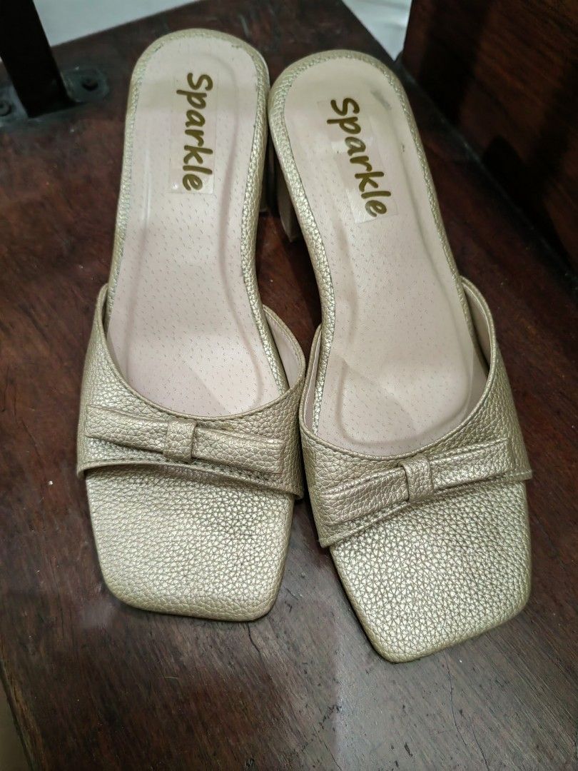 Matte Gold Shoes (Category: Heels) located in Manila. Submitted by mel.cruz (Listing ID 1465610197, Image 2). Description: - Color/Finish: Sparkle gold with a textured metallic exterior - Heel: Solid chunky block heel for easy, stable walking - Design: Square toe front with a cute bow detail on the strap - Style: Convenient slip-on design -Used only once at a wedding. I'm a sneakers and flats kind of a woman so this pair would just gather dust in