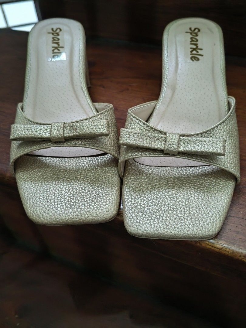 Matte Gold Shoes (Category: Heels) located in Manila. Submitted by mel.cruz (Listing ID 1465610197, Image 3). Description: - Color/Finish: Sparkle gold with a textured metallic exterior - Heel: Solid chunky block heel for easy, stable walking - Design: Square toe front with a cute bow detail on the strap - Style: Convenient slip-on design -Used only once at a wedding. I'm a sneakers and flats kind of a woman so this pair would just gather dust in
