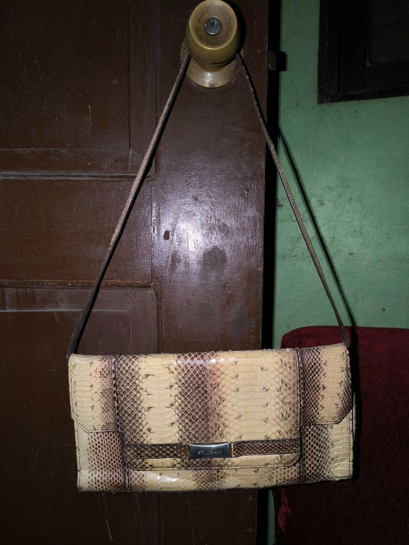 St. John Snakeskin Print Shoulder Bag (Category: Luxury Bags & Wallets) located in Cagayan de Oro. Submitted by fastforest_9c3962 (Listing ID 1465733530, Image 1). Description: - Rare, 100% authentic St. John Couture East-West Baguette Bag. - Trendy snakeskin print in versatile cream and brown tones - Structured rectangular shape with a secure front flap closure - Features a chic metallic hardware accent with the brand name - Comfortable medium-l