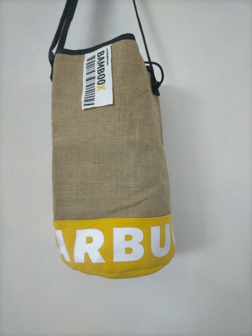 Starbucks Bamboo Bucket Bag (Category: Cross-body Bags) located in Pasay City. Submitted by princessjes143 (Listing ID 1465694511, Image 2). Description: - Authentic Starbucks Bamboo X sling bag - Stylish yellow accent band with bold white Starbucks lettering - Comfortable black adjustable shoulder strap - Fun and colorful floral/leaf pattern interior lining - Includes original white label tag with barcode design - EUC, perfect for casual outings