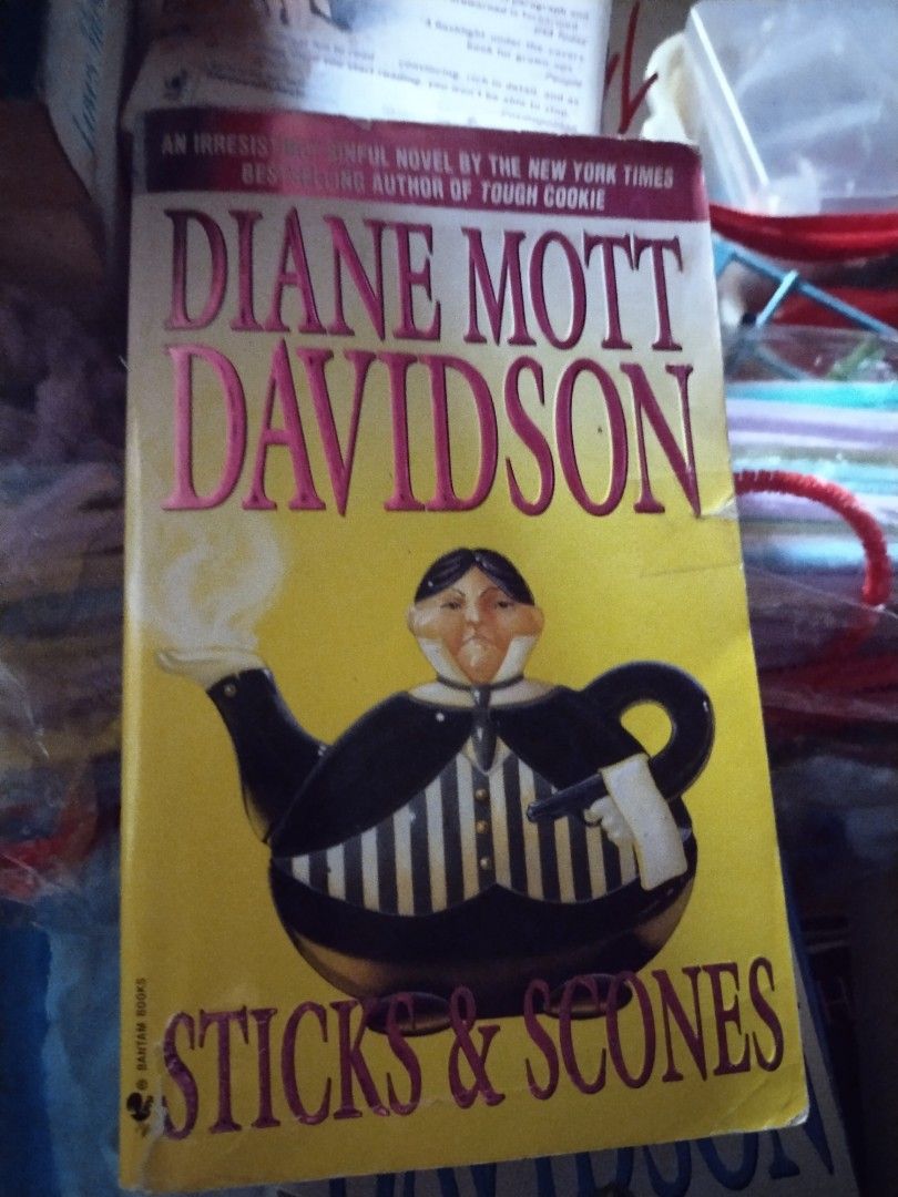 Sticks & Scones by Diane Mott Davidson Novel Paperback (Category: Storybooks) located in Marikina City. Submitted by eruthbb0206 (Listing ID 1465618126, Image 1). Description: - Title & Author: Sticks & Scones by Diane Mott Davidson - Publisher: Bantam Books - Genre: Cozy mystery / Culinary fiction - Cover Design: Yellow cover featuring a teapot illustration - Condition: Readable copy with intact pages and minor shelf wear on edges - Format: Pape