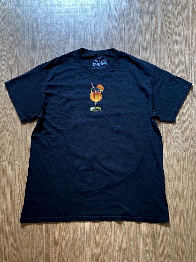 Strange Daze Aperol Spritz Graphic Tee (Category: Shirts) located in Quezon City. Submitted by dcbys (Listing ID 1465617480, Image 2). Description: Classic black crew neck tee with Aperol Spritz chest. Soft, breathable cotton for everyday wear. Clean, simple design that pairs well with jeans or shorts. Features the orange detail for a subtle pop of color. Italy/Spritz graphic on the back..