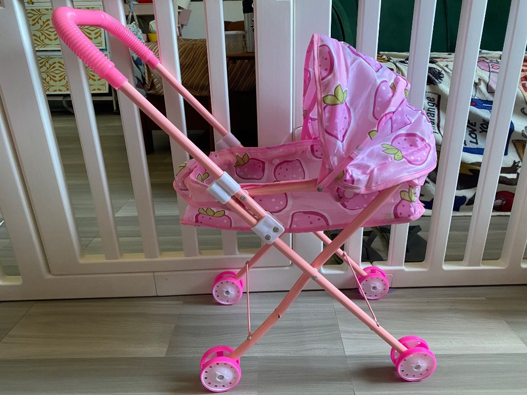 Stroller and carrier w/ mini potty (bundle) (Category: Kids Toys) located in Bauang. Submitted by tinyhandspreloved (Listing ID 1465717155, Image 2). Description: - Complete pink doll accessories playset bundle for pretend play - Foldable strawberry print stroller for easy storage (with minimal flaw) - Authentic Lissi Bätz GmbH unicorn carrier seat with CE tag - Includes a small pink potty bowl - All pieces are clean, well-maintained, and ready f