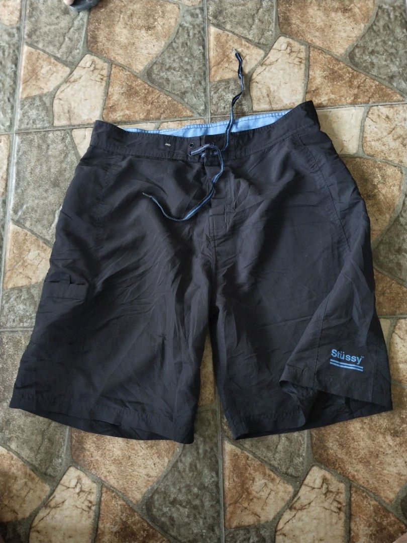 Stussy board short (Category: Swim Trunks & Board Shorts) located in Legazpi City. Submitted by genobecollectives (Listing ID 1465592734, Image 1). Description: Stussy board short - Size: 30-36 - Color: Black with blue accents and logo - Material: 100% polyester (machine washable) - Features: Blue inner waistband, matching drawstring, and right-side cargo pocket - Condition: Great for swimming or casual beach wear 500 free ship.