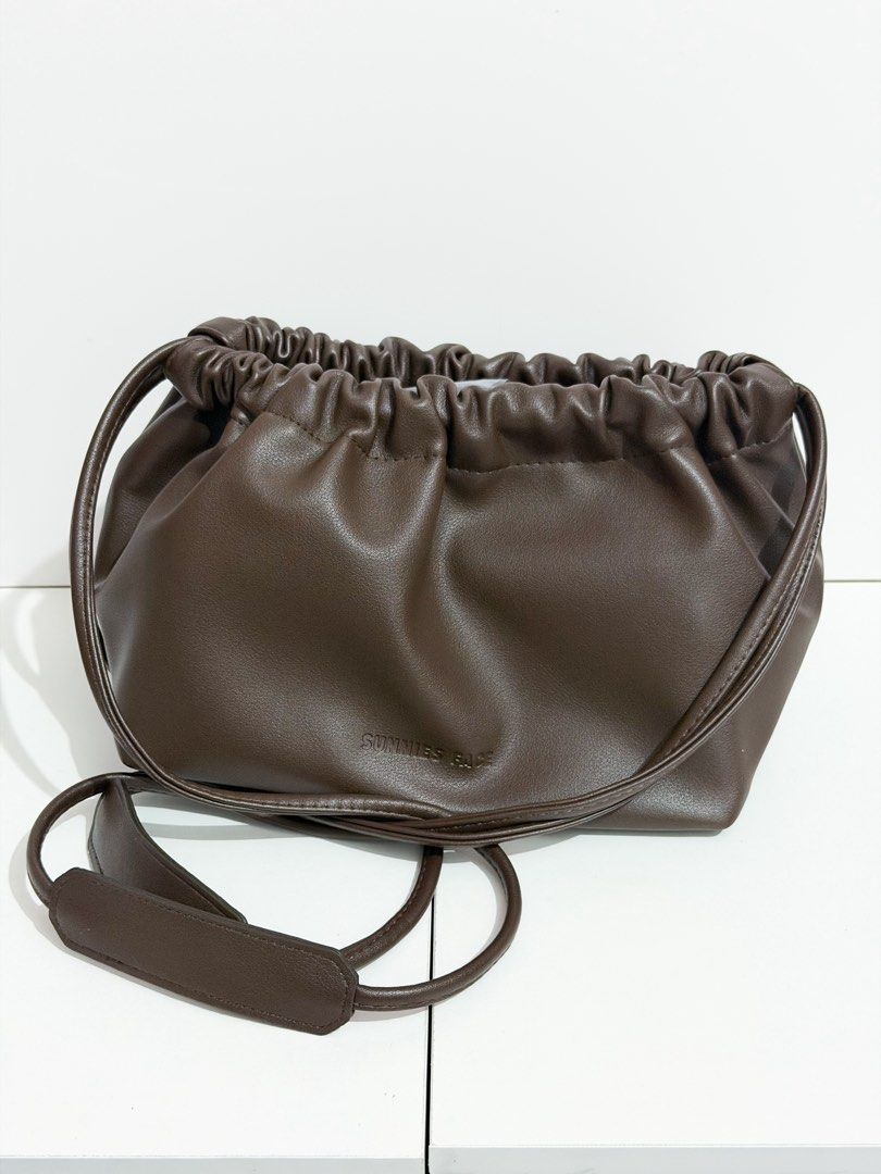 Sunnies Face Dumpling Bag Leather Drawstring Pouch in Cacao (Category: Shoulder Bags) located in Manila. Submitted by tryitoutfirst (Listing ID 1465741015, Image 1). Description: Bnew Sunnies Face Dumpling Bag in Cacao ₱450 .