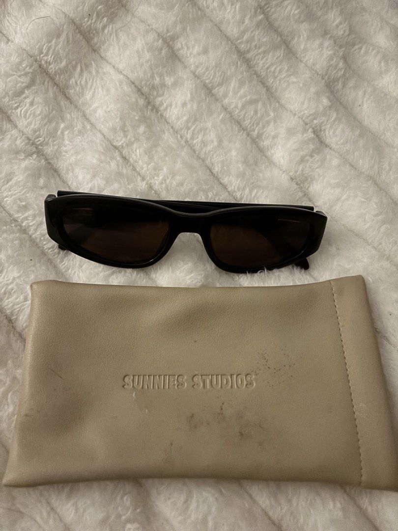 Sunnies Studios Black Sunglasses with Case (Category: Sunglasses & Eyewear) located in Quezon City. Submitted by hadescloset (Listing ID 1465679208, Image 2). Description: - Price is negotiable 🛒 shop more to get discounts and freebies! - Brand: Sunnies Studios - Color: Classic black frames with dark tinted lenses - Condition: Sunglasses are clean and ready to wear - Inclusion: Matching beige leatherette pouch with debossed logo branding (Please
