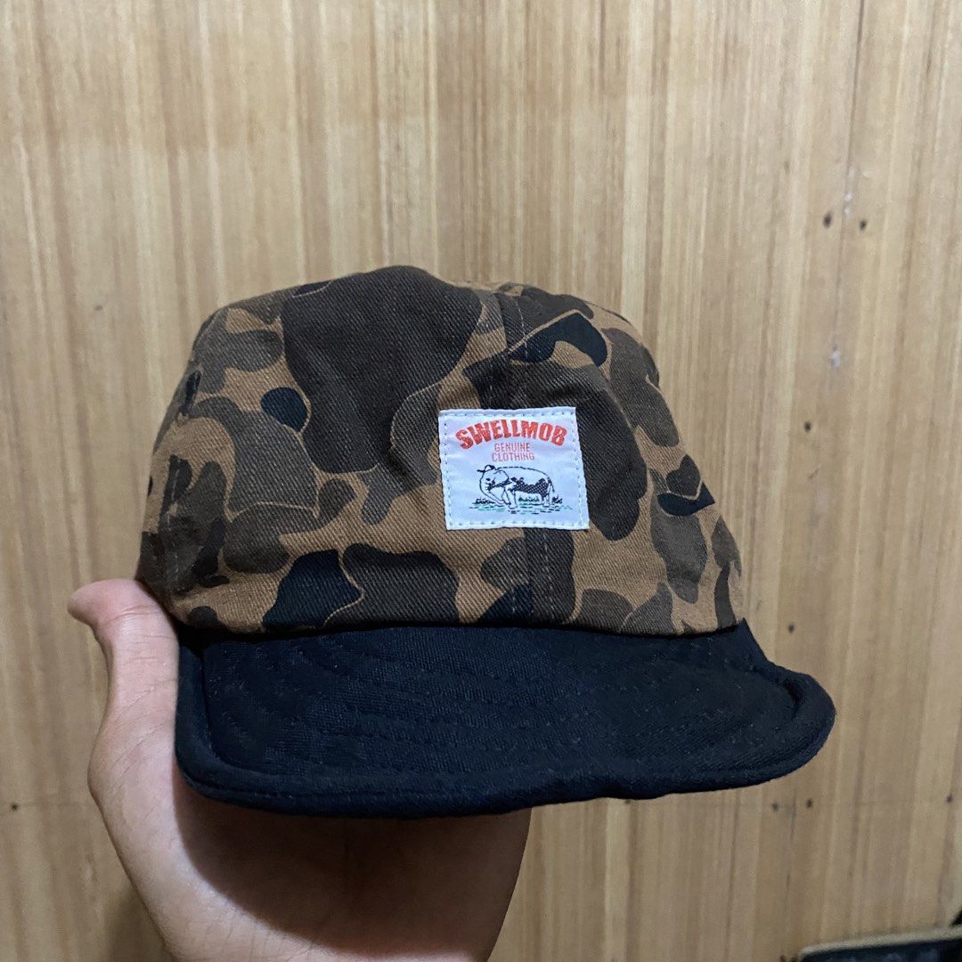 Swellmob Duck Hunter Camo Snapback Cap (Category: Caps & Hats) located in Dipolog. Submitted by thriftcher (Listing ID 1465683051, Image 2). Description: - Brand: Swellmob - Style: Snapback cap with duck hunter camo crown and solid black brim - Fit: Adjustable plastic strap at the back for a custom fit - Details: Sewn-on brand patch on the front panel - Interior: Clean lining with authentic branded tags - Condition: Great pre-loved street style p