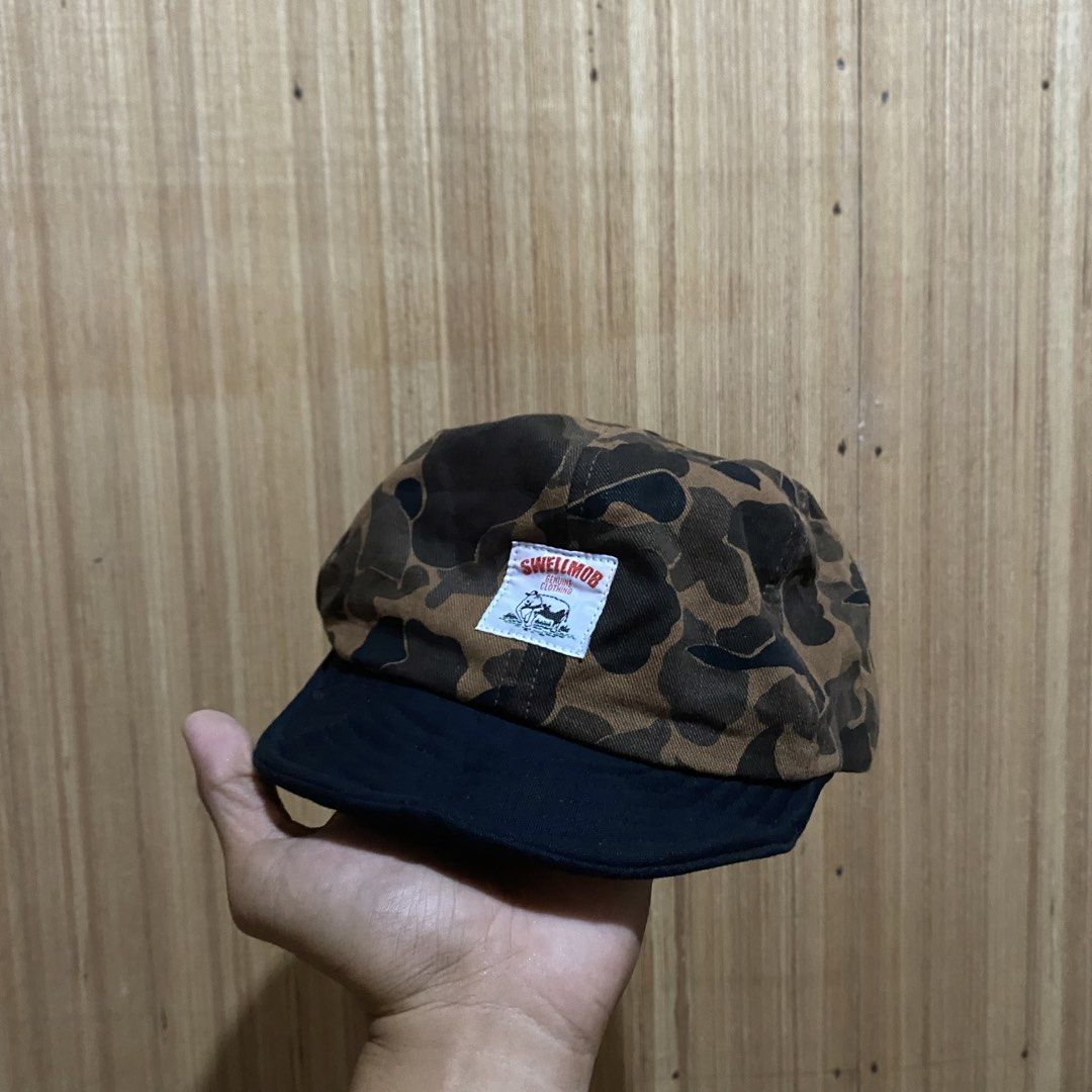 Swellmob Duck Hunter Camo Snapback Cap (Category: Caps & Hats) located in Dipolog. Submitted by thriftcher (Listing ID 1465683051, Image 1). Description: - Brand: Swellmob - Style: Snapback cap with duck hunter camo crown and solid black brim - Fit: Adjustable plastic strap at the back for a custom fit - Details: Sewn-on brand patch on the front panel - Interior: Clean lining with authentic branded tags - Condition: Great pre-loved street style p