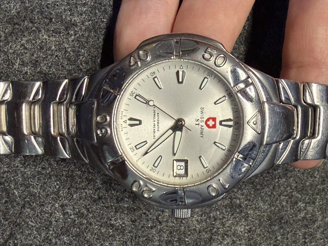 Swiss Army ST Automatic Watch (Category: Men's Watches) located in Pasay City. Submitted by gadgets_atbp (Listing ID 1465665975, Image 3). Description: Genuine / Authentic Swiss Army Swiss Army ST automatic watch Dial: silver-tone dial and rotating bezel Movement: Automatic 25 jewels incabloc bracelet: Stainless steel construction with a linked bracelet and deployment clasp Date: window positioned near the 4 o'clock Scuffs and scratches on the cr