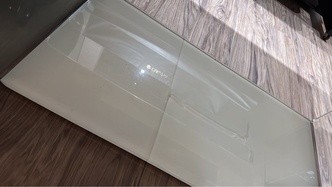Table (Category: Tables & Sets) located in Singapore. Submitted by dordot (Listing ID 1465623165, Image 3). Description: Bought more than $3000 Tempered glass table 1cm thick 190cm L x 90cm W Photos shown screws in both sides to dismantle Note that base has crack lines (shown in photo) But no issue using as the base made of wood! Can put a nice carpet on if you want to cover up (very steady glass) Not for picky buyer Buyer own transport - collect