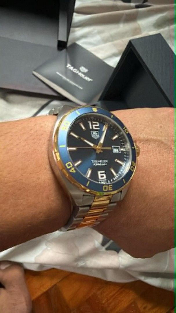 TAG Heuer Formula 1 Two-Tone Blue Dial Watch (Category: Luxury Watches) located in Manila. Submitted by mylenearte22319 (Listing ID 1465626755, Image 3). Description: - Brand/Model: TAG Heuer Formula 1 Quartz Watch - Design: Blue sunburst dial with gold indices and rotating blue bezel - Bracelet: Two-tone steel and gold (minor hairline scratches from careful use) - Movement: Battery-powered quartz - Inclusions: Original box, user manual, warranty
