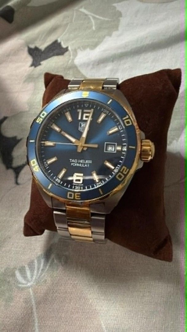 TAG Heuer Formula 1 Two-Tone Blue Dial Watch (Category: Luxury Watches) located in Manila. Submitted by mylenearte22319 (Listing ID 1465626755, Image 2). Description: - Brand/Model: TAG Heuer Formula 1 Quartz Watch - Design: Blue sunburst dial with gold indices and rotating blue bezel - Bracelet: Two-tone steel and gold (minor hairline scratches from careful use) - Movement: Battery-powered quartz - Inclusions: Original box, user manual, warranty