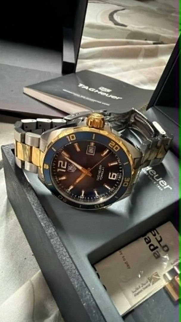 TAG Heuer Formula 1 Two-Tone Blue Dial Watch (Category: Luxury Watches) located in Manila. Submitted by mylenearte22319 (Listing ID 1465626755, Image 1). Description: - Brand/Model: TAG Heuer Formula 1 Quartz Watch - Design: Blue sunburst dial with gold indices and rotating blue bezel - Bracelet: Two-tone steel and gold (minor hairline scratches from careful use) - Movement: Battery-powered quartz - Inclusions: Original box, user manual, warranty