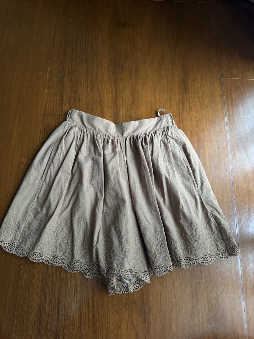 Taupe Embroidered Lace Hem Skort (Category: Skirts) located in Pasig City. Submitted by kutleyn (Listing ID 1465698293, Image 1). Description: - Color: Neutral taupe (earth tone) - Fit: High waist with comfortable movement and easy slip-on style - Design: Gathered pleats with built-in shorts underneath - Details: Floral embroidery and scalloped crochet lace edge along the bottom hem - Versatile: Easy to match with various tops for a chic, casual 