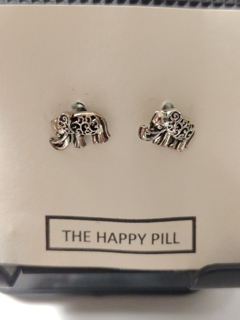 The Happy Pill Stud Earrings Assorted Styles (Category: Earrings) located in Antipolo. Submitted by goodsinger (Listing ID 1465603915, Image 2). Description: - Adorable stud earrings mounted on unique 'Happy Pill' display cards - Variety of cute designs available: elephants, locks, bunnies, butterflies, turquoise stones, and lollipops - Features standard post backs for comfortable daily wear - Fun and playful collection, great for mixing and matc