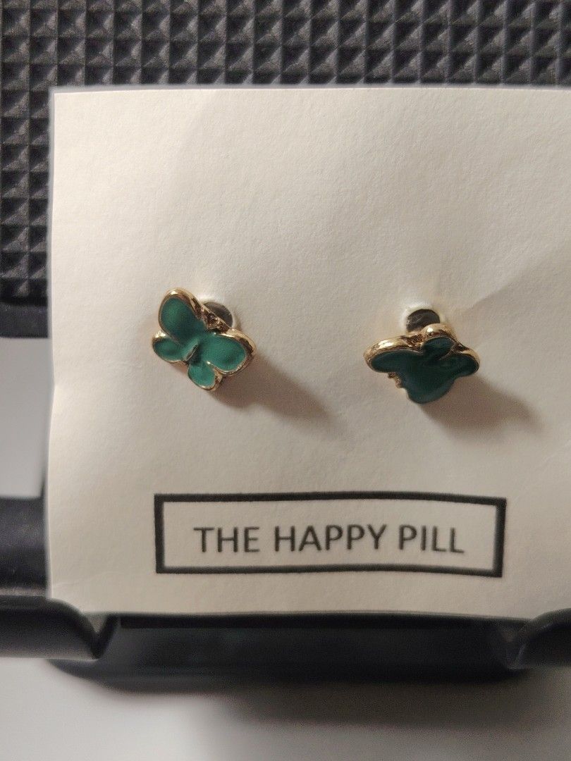 The Happy Pill Stud Earrings Assorted Styles (Category: Earrings) located in Antipolo. Submitted by goodsinger (Listing ID 1465603915, Image 3). Description: - Adorable stud earrings mounted on unique 'Happy Pill' display cards - Variety of cute designs available: elephants, locks, bunnies, butterflies, turquoise stones, and lollipops - Features standard post backs for comfortable daily wear - Fun and playful collection, great for mixing and matc