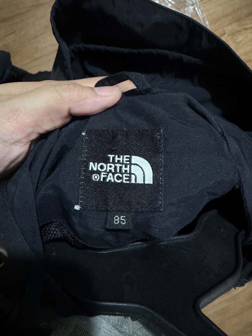 The North Face Black Hooded Jacket Size 85 (Category: Coats, Jackets and Outerwear) located in Mandaluyong City. Submitted by zaiampiloquio (Listing ID 1465608421, Image 2). Description: - Brand: The North Face - Color: Classic Black - Size: 85 (fits S/M) - Features: Full zip with wind flap, adjustable hood and hem drawstrings - Pockets: Two secure zippered hand pockets - Details: Embroidered logo on chest and sleeve - Condition: Clean and well-m