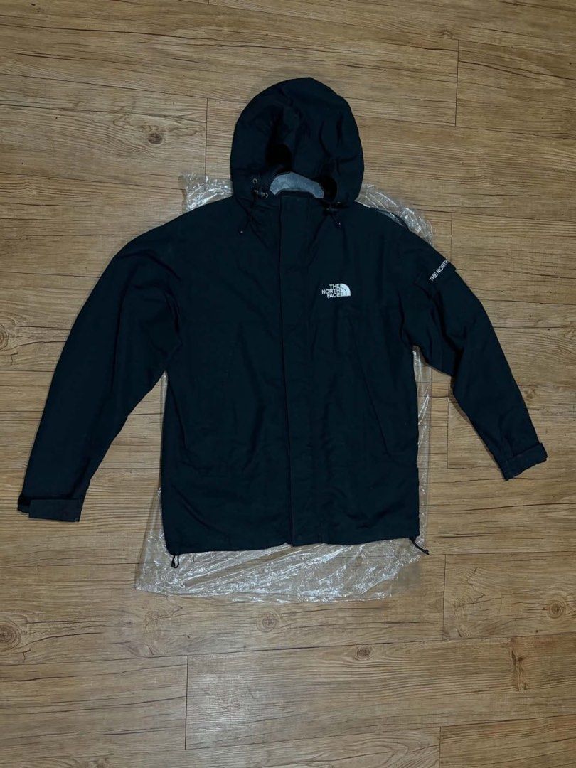 The North Face Black Hooded Jacket Size 85 (Category: Coats, Jackets and Outerwear) located in Mandaluyong City. Submitted by zaiampiloquio (Listing ID 1465608421, Image 3). Description: - Brand: The North Face - Color: Classic Black - Size: 85 (fits S/M) - Features: Full zip with wind flap, adjustable hood and hem drawstrings - Pockets: Two secure zippered hand pockets - Details: Embroidered logo on chest and sleeve - Condition: Clean and well-m