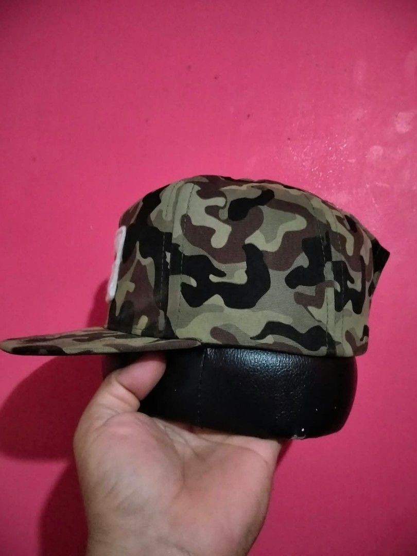 The Primitive Company Camouflage Snapback Cap (Category: Caps & Hats) located in Mangaldan. Submitted by niftythrifty69 (Listing ID 1465615232, Image 3). Description: - Brand: The Primitive Company - Design: Green camouflage with white felt patch and red embroidered script - Brim: Classic flat brim - Closure: Adjustable black plastic snapback with brand logo - Style: Streetwear essential, versatile for casual everyday wear - Condition: Excellent/