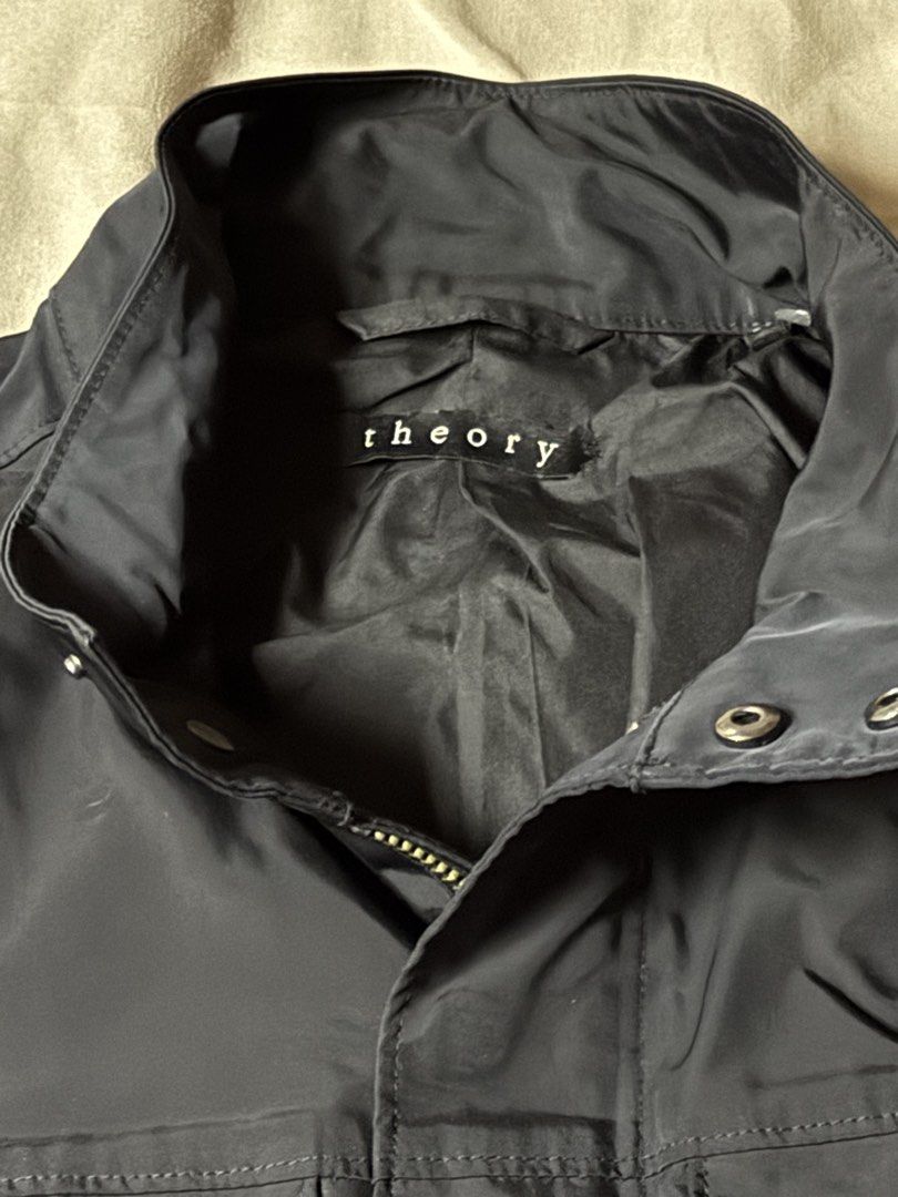 Theory Black Utility Jacket (Category: Coats, Jackets and Outerwear) located in Manila. Submitted by seangoart (Listing ID 1465585721, Image 2). Description: - Brand: Theory - Color: Classic Black - Material: Lightweight and breathable, perfect for PH weather - Design: Stand collar, full zip with snap placket, button cuffs - Pockets: Two large front flap chest pockets - Condition: Clean lining inside, well-maintained - Style: Versatile outer laye