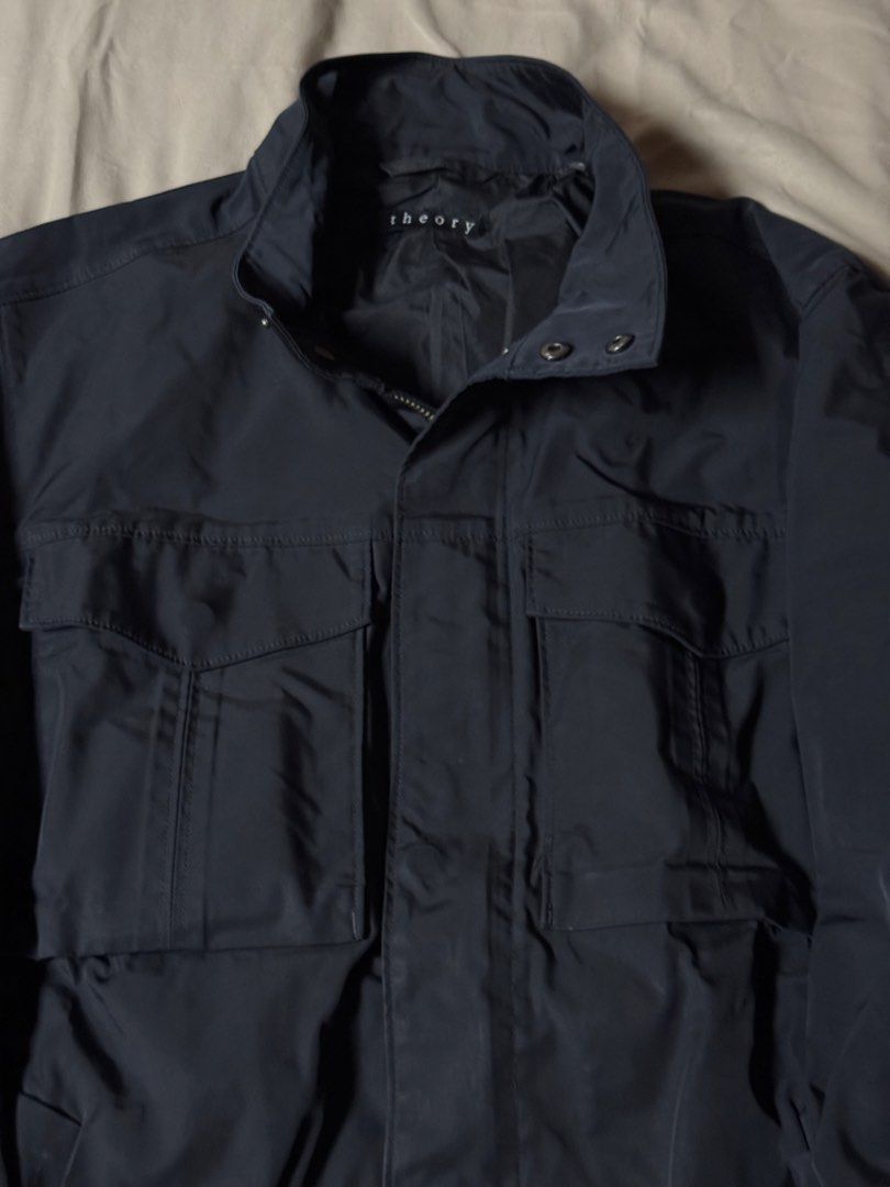 Theory Black Utility Jacket (Category: Coats, Jackets and Outerwear) located in Manila. Submitted by seangoart (Listing ID 1465585721, Image 3). Description: - Brand: Theory - Color: Classic Black - Material: Lightweight and breathable, perfect for PH weather - Design: Stand collar, full zip with snap placket, button cuffs - Pockets: Two large front flap chest pockets - Condition: Clean lining inside, well-maintained - Style: Versatile outer laye