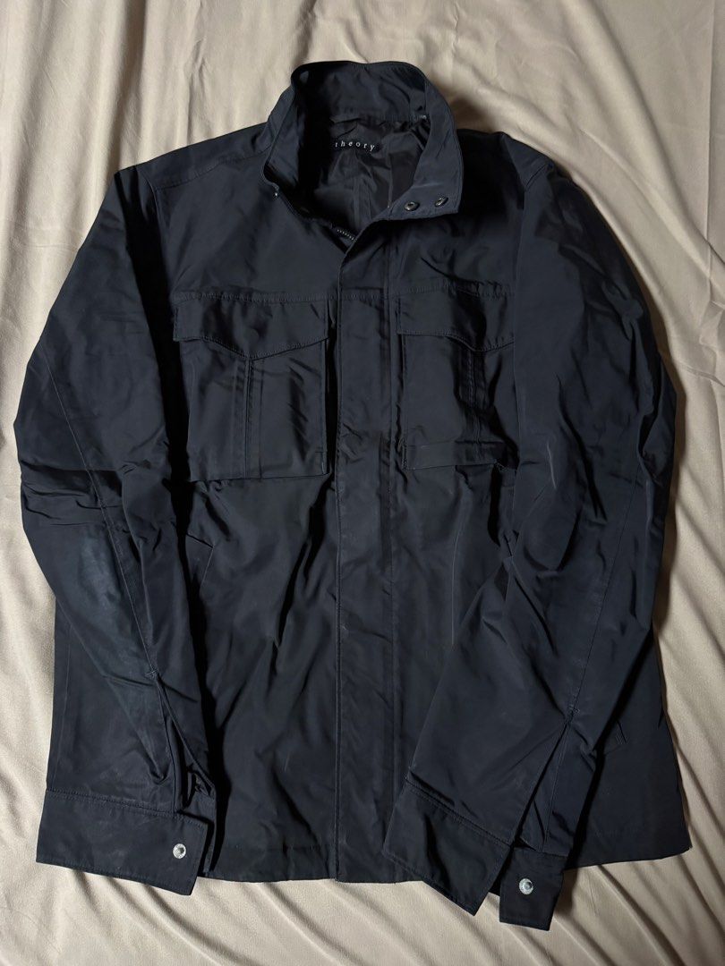 Theory Black Utility Jacket (Category: Coats, Jackets and Outerwear) located in Manila. Submitted by seangoart (Listing ID 1465585721, Image 1). Description: - Brand: Theory - Color: Classic Black - Material: Lightweight and breathable, perfect for PH weather - Design: Stand collar, full zip with snap placket, button cuffs - Pockets: Two large front flap chest pockets - Condition: Clean lining inside, well-maintained - Style: Versatile outer laye
