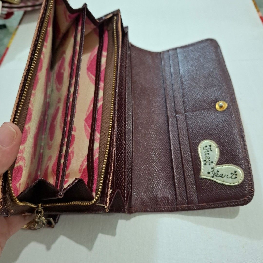 Think Bee! Long Wallet with Hearts and Tassel (Category: Wallets & Card holders) located in Don Carlos. Submitted by PphiXi_Finds (Listing ID 1465725213, Image 3). Description: - Brand: Think Bee! - Material: Brown leather trim and patterned fabric - Exterior: Colorful embroidered heart appliques, sequins, and green/pink hearts on the back - Interior: Pink heart-patterned fabric with multiple card slots and zipped compartments - Extras: Detachabl
