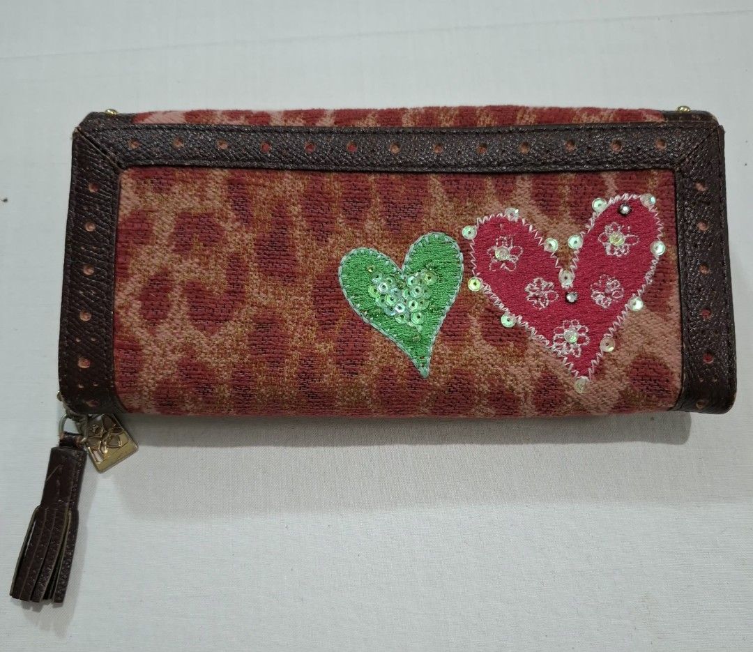 Think Bee! Long Wallet with Hearts and Tassel (Category: Wallets & Card holders) located in Don Carlos. Submitted by PphiXi_Finds (Listing ID 1465725213, Image 2). Description: - Brand: Think Bee! - Material: Brown leather trim and patterned fabric - Exterior: Colorful embroidered heart appliques, sequins, and green/pink hearts on the back - Interior: Pink heart-patterned fabric with multiple card slots and zipped compartments - Extras: Detachabl