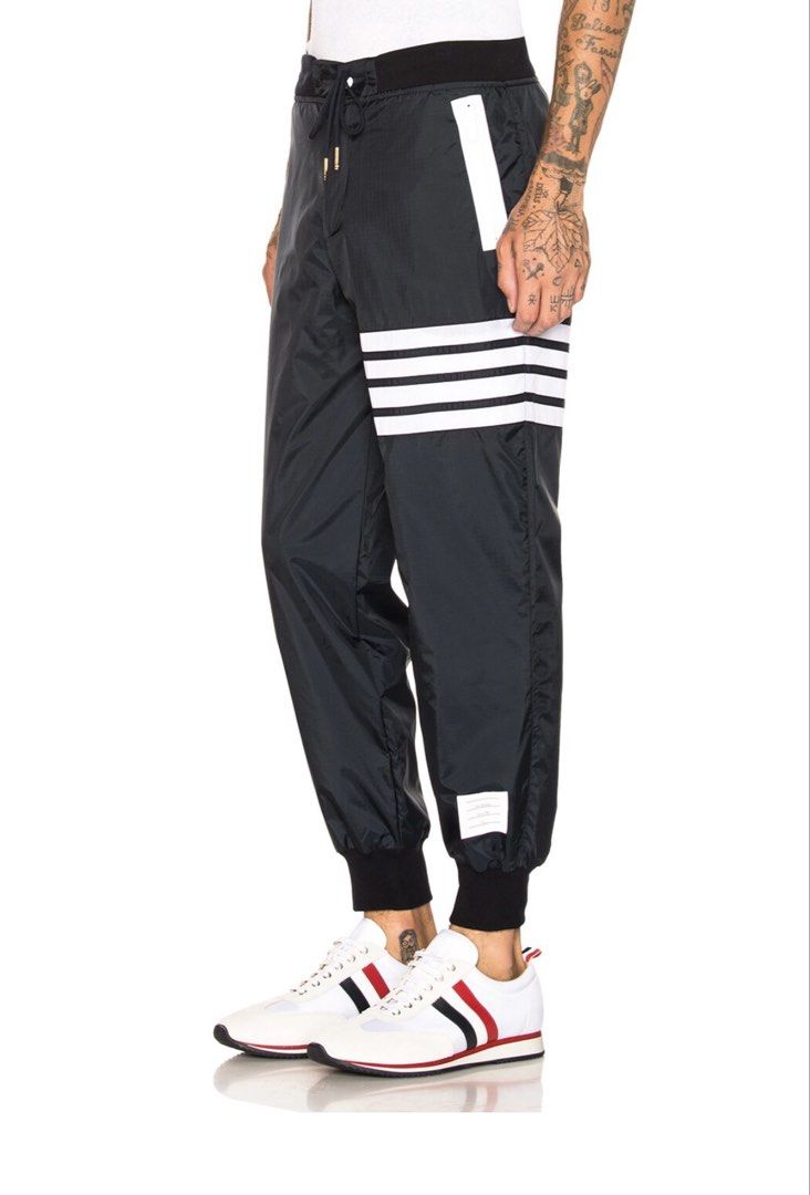 THOM BROWNE Light Weight Sweatpants (Category: Joggers) located in Manila. Submitted by walter_wt (Listing ID 1465663216, Image 2). Description: THOM BROWNE 4 bar Light Weight Nylon Sweatpants Tagged Size- 3 Dimension- Waistline: 34-36 Length: 38 -Made in Italy -Drawstring elastic waist -Zip fly and button closure -Mesh lined -Side zip pockets Self: 100% nylon -Lining: 100% polyamide -Trim: 95% cotton, 5% elastane -Rib knit trim -No issue .