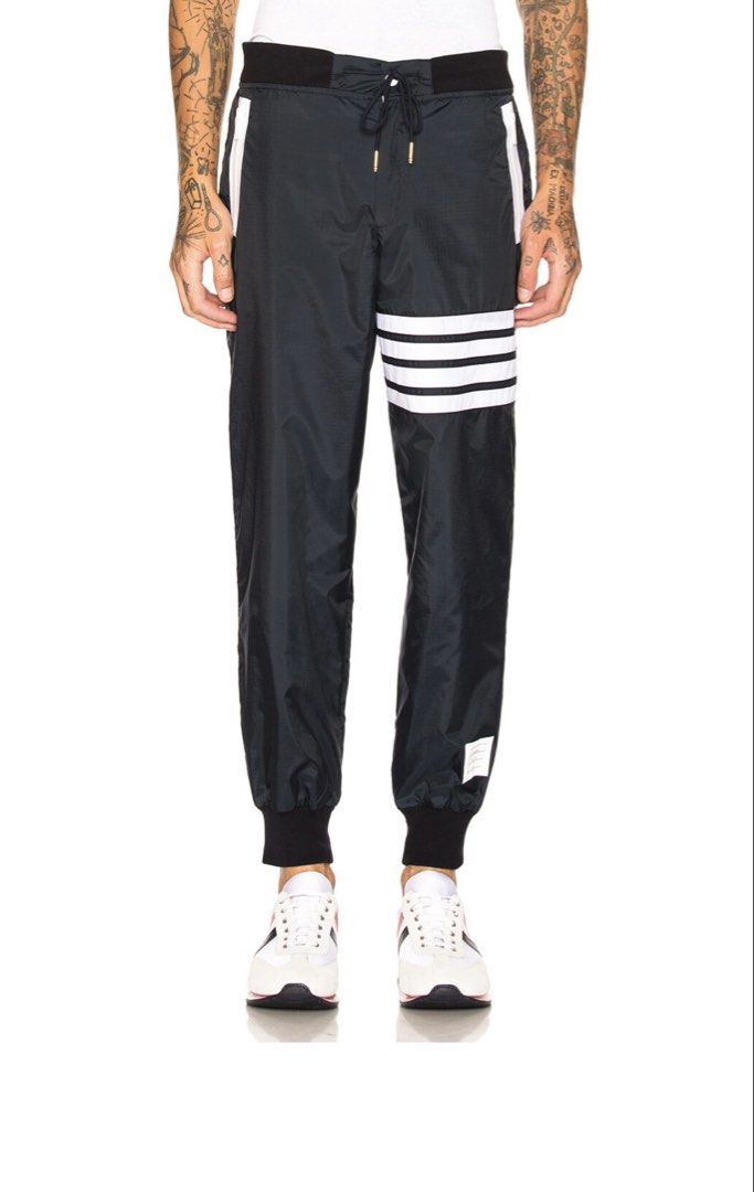 THOM BROWNE Light Weight Sweatpants (Category: Joggers) located in Manila. Submitted by walter_wt (Listing ID 1465663216, Image 1). Description: THOM BROWNE 4 bar Light Weight Nylon Sweatpants Tagged Size- 3 Dimension- Waistline: 34-36 Length: 38 -Made in Italy -Drawstring elastic waist -Zip fly and button closure -Mesh lined -Side zip pockets Self: 100% nylon -Lining: 100% polyamide -Trim: 95% cotton, 5% elastane -Rib knit trim -No issue .