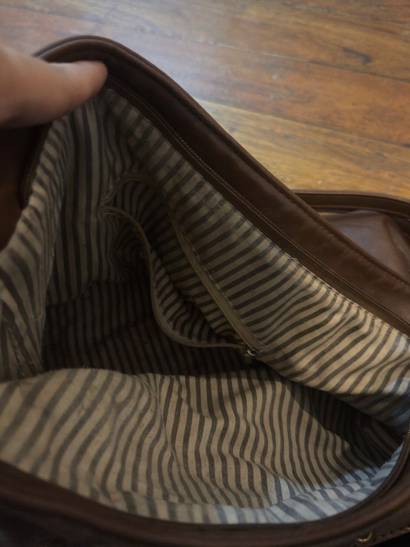 Three way Brown suede shoulder bag with strap detail (Category: Shoulder Bags) located in Taguig. Submitted by princesssantoss (Listing ID 1465586747, Image 2). Description: - Material: Brown faux suede with brass-toned hardware - Closure: Secure zip-top closure - Interior: Cute striped fabric lining with a handy zippered pocket - Capacity: Roomy enough for your daily essentials - Straps: Dual shoulder straps for comfortable carrying.