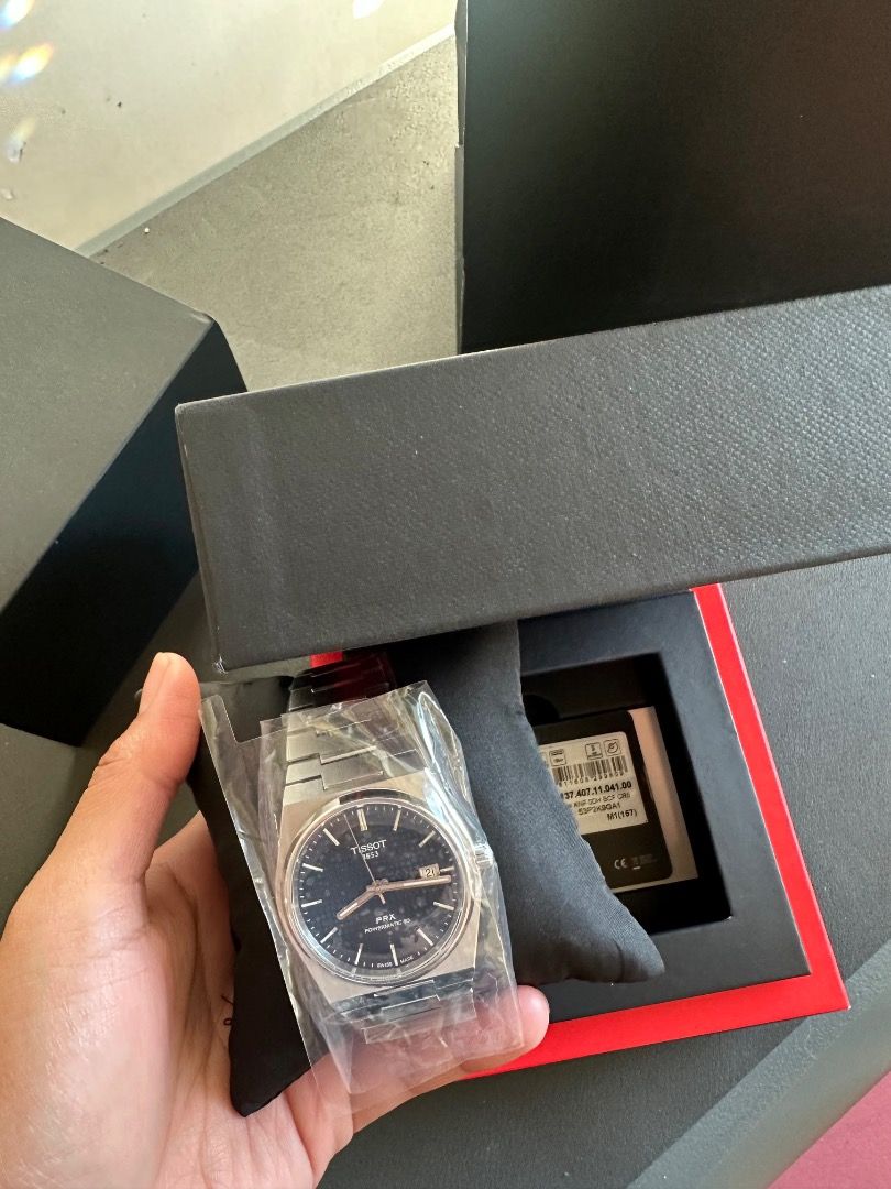 Tissot PRX Powermatic 80 Watch (Category: Men's Watches) located in Mandaluyong City. Submitted by emyr7 (Listing ID 1465582813, Image 2). Description: Selling a brand new, unworn Tissot PRX Powermatic 80 with blue waffle dial and stainless steel bracelet. * Swiss Made Automatic (Powermatic 80) * 40mm case * Sapphire crystal * Complete with box, warranty card, manuals, and extra links * All factory plastics and stickers still intact (opened only 