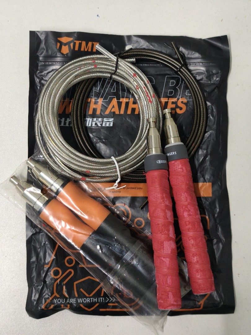 TMT Crossfit Jump Rope with Extra Cables (Category: Cardio & Fitness Machines) located in San Jose del Monte. Submitted by missalipot (Listing ID 1465746542, Image 1). Description: - Brand: TMT Speed Rope - Handles: 2 sets included (one wrapped in red tape, one in black tape) - Cables: 2 durable steel cables (silver and dark grey) - Storage: Comes with original black packaging bag - Condition: Excellent, ready for workouts.