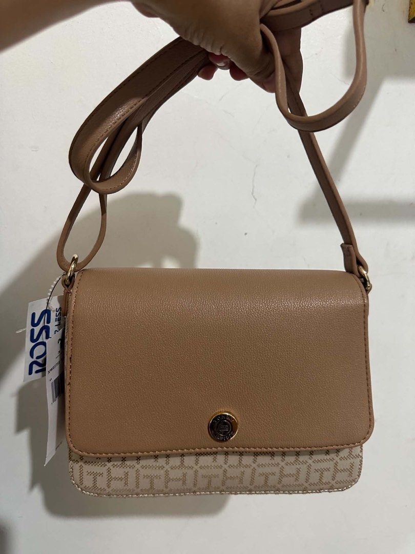 Tommy Hilfiger Monogram Crossbody Bag (Category: Cross-body Bags) located in Dagupan City. Submitted by vallureph (Listing ID 1465588511, Image 2). Description: - Brand: Tommy Hilfiger - Style: Classic flap crossbody bag - Color/Pattern: Tan and beige monogram - Hardware: Gold-tone with signature TH charm - Strap: Adjustable for comfortable wear - Interior: Roomy enough for everyday essentials - Condition: Brand new with original Ross store tags.