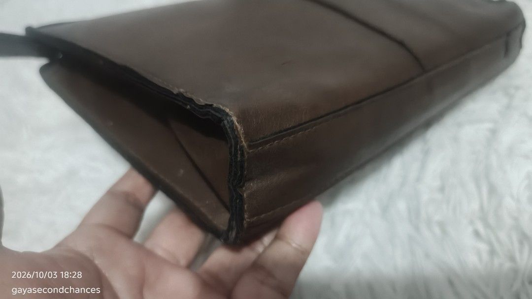 TOP GALLANT BROWN LEATHER CLUTCH BAG (Category: Belt bags, Clutches and Pouches) located in Kalibo. Submitted by secondchances.thriftsh8p (Listing ID 1465677557, Image 3). Description: - Brand: Top Gallant - Material: Brown leather - Closure: Secure zip-around design - Pocket: Handy front zippered pocket - Structure: Holds its shape with reinforced black side gussets - Details: Metal brand plaque and solid hardware.