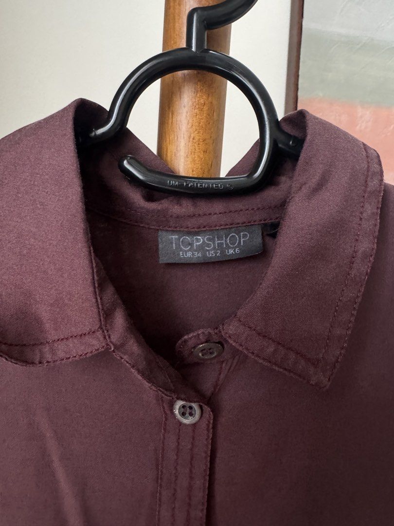 Topshop Burgundy Long Sleeve Button Down (Category: Longsleeves) located in Pasig City. Submitted by kutleyn (Listing ID 1465656707, Image 2). Description: - Brand: Topshop - Color: Rich burgundy - Size: EUR 34 / US 2 / UK 6 - Features: Long sleeves, chest pockets, classic collar, and front button placket - Material: Lightweight and versatile - Condition: Clean, excellent pre-loved condition.