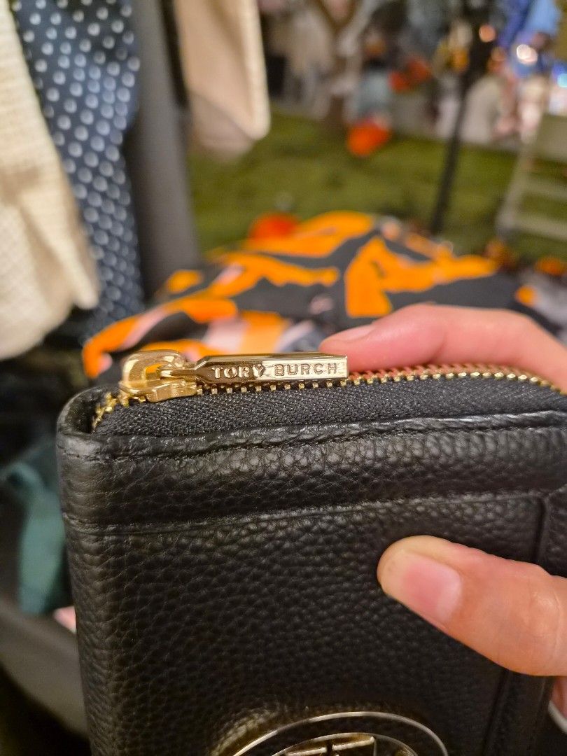 Tory Burch Black Leather Zip Continental Wallet (Category: Wallets & Card holders) located in Paranaque City. Submitted by regf_01 (Listing ID 1465668802, Image 2). Description: - Authentic Tory Burch zip-around wallet in black pebbled leather - Elegant gold-tone hardware and embossed logo zipper pull - Multiple card slots, bill compartments, and secure zippered coin pocket - Interior features classic gold foil Tory Burch stamp - Clean grain text