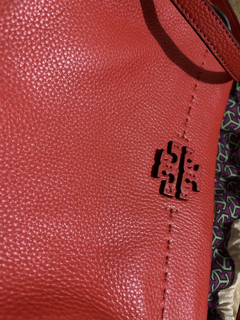 Tory Burch Red Leather Crossbody Bag (Category: Luxury Bags & Wallets) located in Quezon City. Submitted by pickleballpaddle (Listing ID 1465626428, Image 2). Description: - Brand: Tory Burch - Color: Bright Red - Material: Genuine pebbled leather - Hardware: Gold-tone - Closure: Top zip - Strap: Adjustable - Interior: Fabric lined with zip pocket and metal logo plaque - Inclusions: Dust bag included - Condition: Clean pebble texture, great every