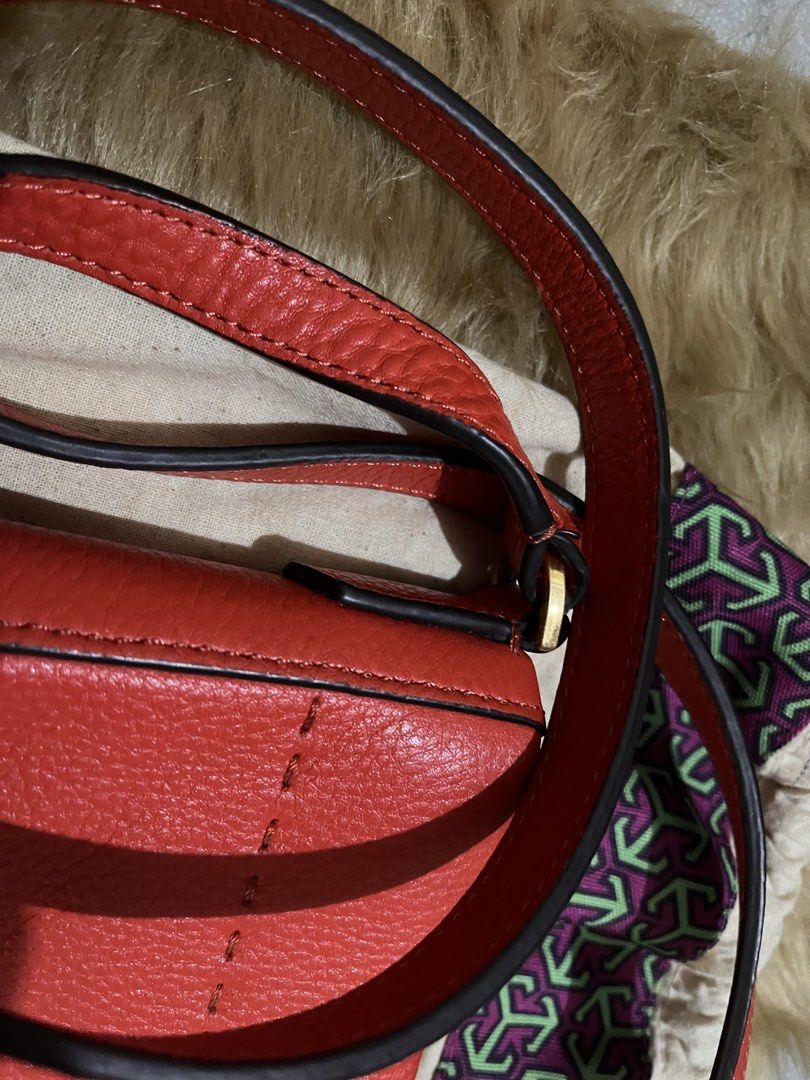 Tory Burch Red Leather Crossbody Bag (Category: Luxury Bags & Wallets) located in Quezon City. Submitted by pickleballpaddle (Listing ID 1465626428, Image 3). Description: - Brand: Tory Burch - Color: Bright Red - Material: Genuine pebbled leather - Hardware: Gold-tone - Closure: Top zip - Strap: Adjustable - Interior: Fabric lined with zip pocket and metal logo plaque - Inclusions: Dust bag included - Condition: Clean pebble texture, great every