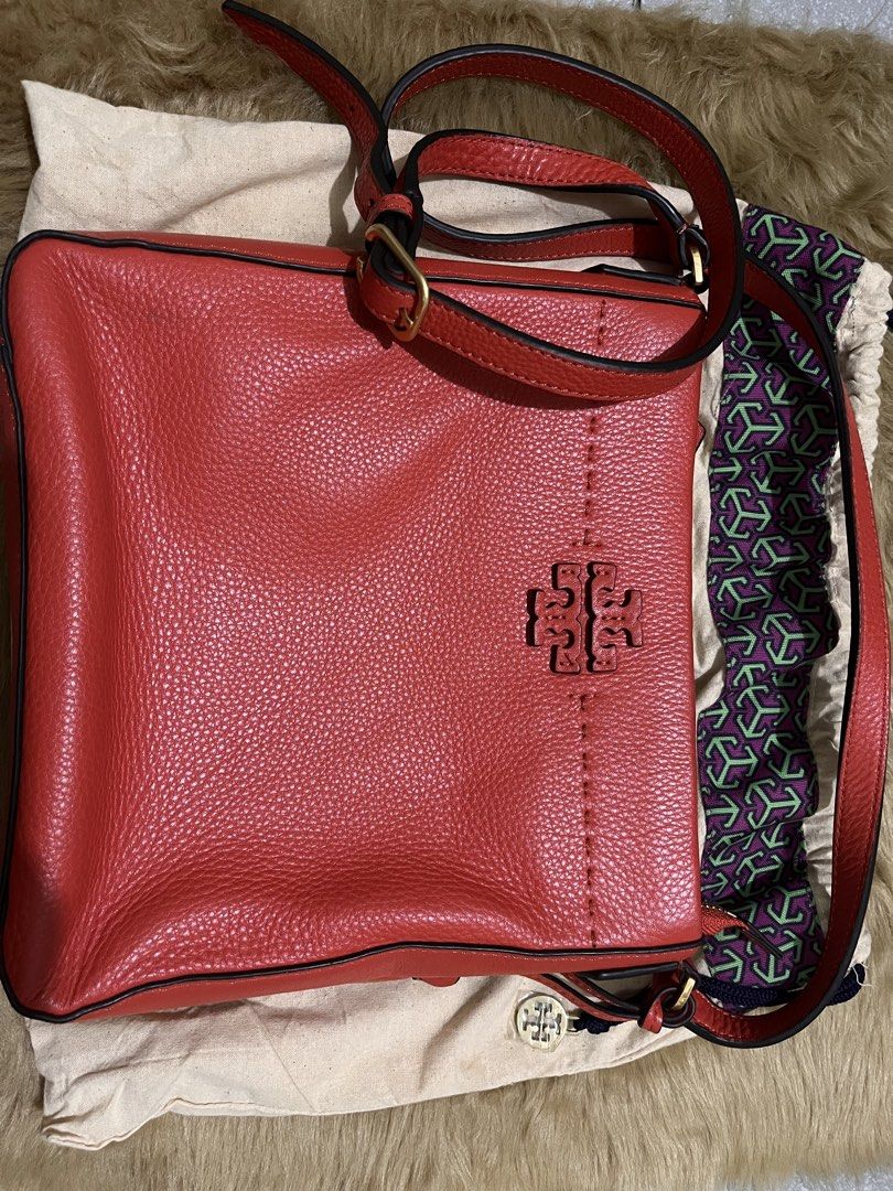 Tory Burch Red Leather Crossbody Bag (Category: Luxury Bags & Wallets) located in Quezon City. Submitted by pickleballpaddle (Listing ID 1465626428, Image 1). Description: - Brand: Tory Burch - Color: Bright Red - Material: Genuine pebbled leather - Hardware: Gold-tone - Closure: Top zip - Strap: Adjustable - Interior: Fabric lined with zip pocket and metal logo plaque - Inclusions: Dust bag included - Condition: Clean pebble texture, great every