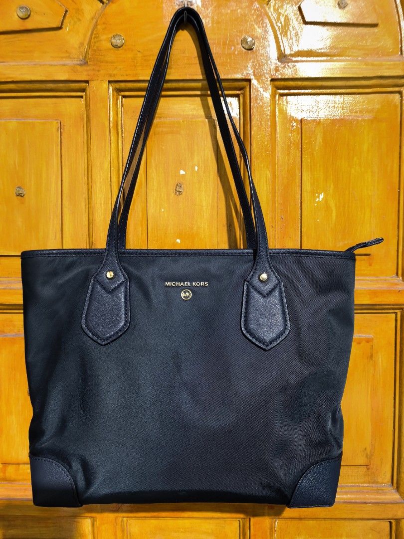 Tote bag (Category: Tote Bags) located in Manila. Submitted by khulet2008 (Listing ID 1465667180, Image 1). Description: Nylon and leather handle M-K tote bag Navy blue color. Excellent condition.