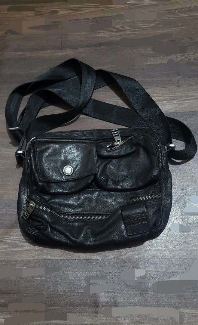 TOUGH Jeansmith Black Leather Sling Bag (Category: Sling Bags) located in San Juan City. Submitted by sniffandstyle (Listing ID 1464061538, Image 1). Description: - Brand: TOUGH - Color: Black - Material: Leather - Style: Crossbody bag - Compartments: Multiple zip compartments, interior zip pocket, front flap pocket with button closure - Strap: Adjustable - Condition: Used in very good condition/ distressed military design - Ideal for: Everyday u