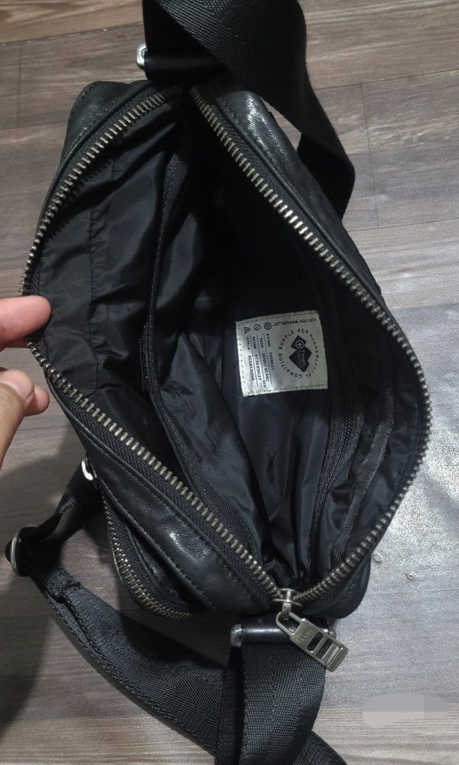 TOUGH Jeansmith Black Leather Sling Bag (Category: Sling Bags) located in San Juan City. Submitted by sniffandstyle (Listing ID 1464061538, Image 2). Description: - Brand: TOUGH - Color: Black - Material: Leather - Style: Crossbody bag - Compartments: Multiple zip compartments, interior zip pocket, front flap pocket with button closure - Strap: Adjustable - Condition: Used in very good condition/ distressed military design - Ideal for: Everyday u