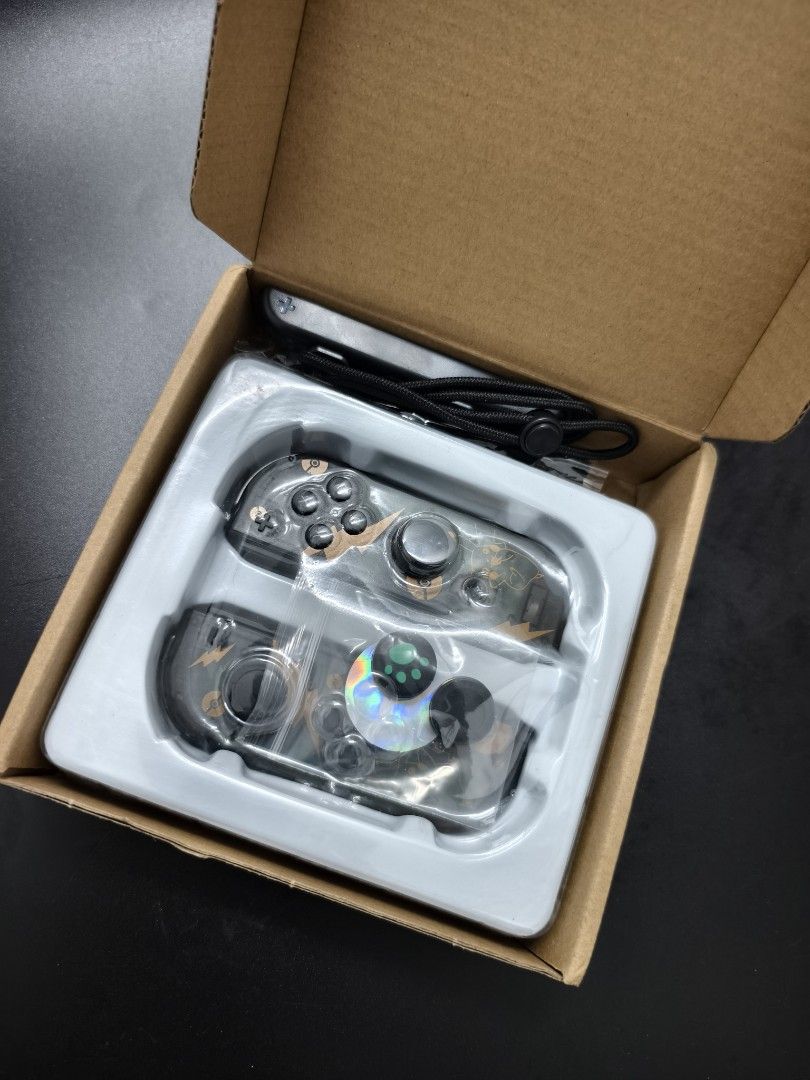 Transparent Black Pikachu Nintendo Switch Joy-Con Shell Replacement (Category: Controllers) located in Angeles City. Submitted by measaliman02351 (Listing ID 1465736086, Image 2). Description: - Condition: Brand new, unused in original box and plastic tray - Design: Transparent black with custom Pikachu and lightning bolt graphics - Compatibility: Replacement housings for Nintendo Switch Joy-Cons - Includes: Matching wrist straps and thumb grip c
