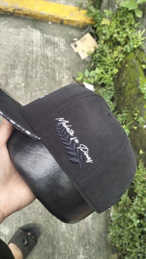 Tribal Gear x Gloc-9 Snapback Cap Black (Category: Caps & Hats) located in Manila. Submitted by chrisyoung01 (Listing ID 1465641104, Image 2). Description: - Style: Black snapback cap with standard fit and sturdy build - Front: Metallic silver Tribal logo - Side: 'Makata sa Pinas' embroidery with leaf design - Back: Gloc-9 patch and adjustable plastic strap .