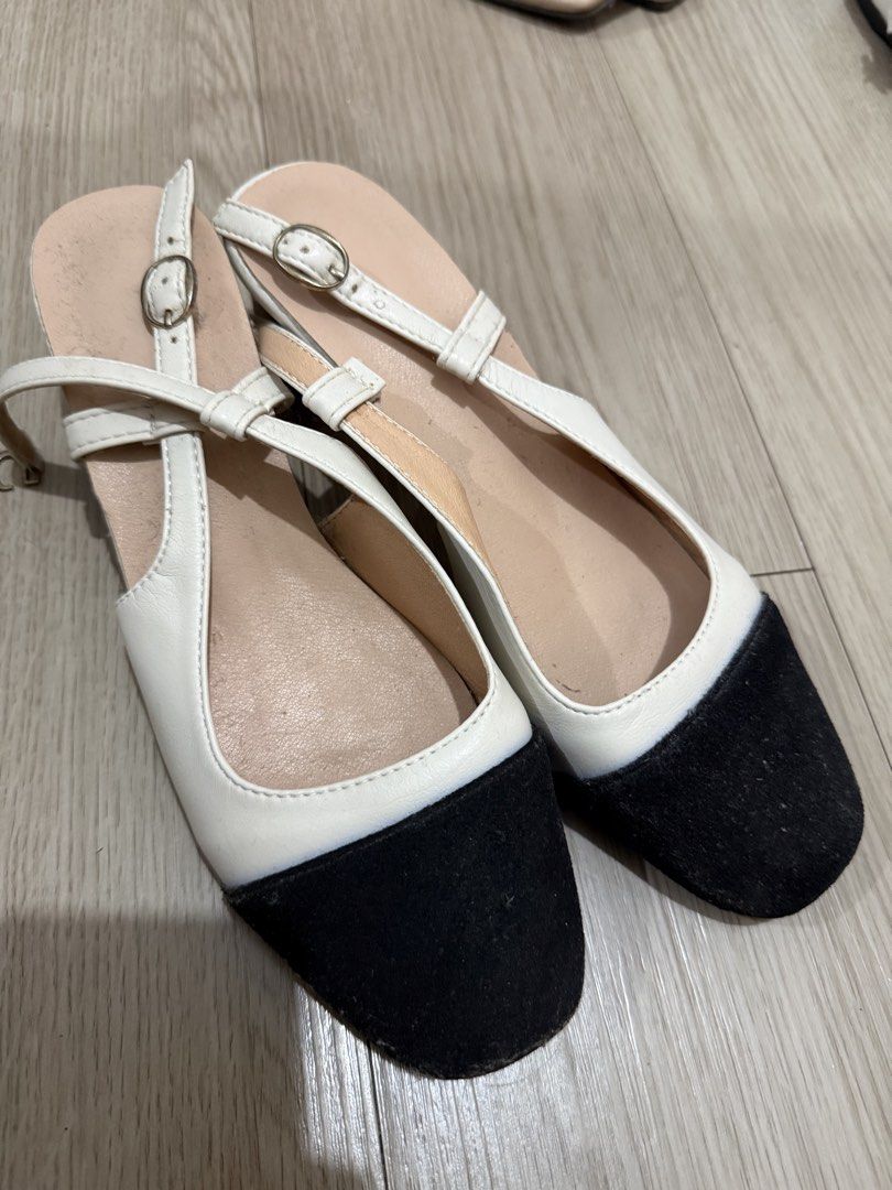 Two-tone Black and White Slingback Heels (Category: Heels) located in Manila. Submitted by aaaine (Listing ID 1465755741, Image 3). Description: - Color: Classic black and white two-tone design - Toe Style: Closed square toe - Heel: Comfortable low block heel - Fit: Adjustable buckle strap at the back heel with stylish crisscross side straps - Interior: Neutral beige inner lining - Condition: Brand new / Excellent quality - Perfect for: Office we